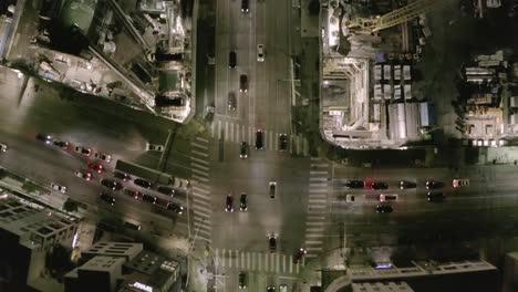 AERIAL:-Overhead-View-of-Cinematic-Street-at-Night-in-Los-Angeles-with-Car-Traffic-Lights