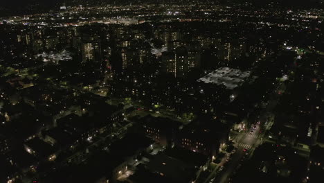 AERIAL:-Dark-Apartment-Towers-,-Complex-in-Hollywood-Los-Angeles,-California-at-Night