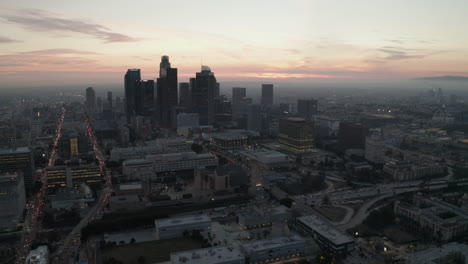 AERIAL:-Breathtaking-view-of-skyscrapers-in-Downtown-Los-Angeles,-California-at-beautiful-Sunset