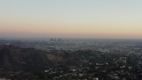 AERIAL:-View-over-Los-Angeles-in-Hollywood-Hills-at-Sunset,-Los-Angeles,-California
