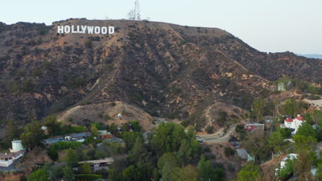 AERIAL:-Looking-up-to-Hollywood-Sign,Letters-in-Hollywood-Hills-at-Sunset,-Los-Angeles,-California