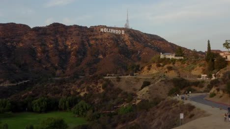 AERIAL:-Wide-Shot-flying-towards-Hollywood-Sign-Letters-at-Sunset,-Los-Angeles,-California