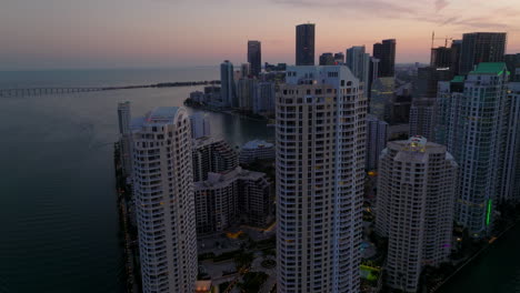 Modern-tall-apartment-buildings-in-residential-complex-on-waterfront.-Aerial-evening-view-of-modern-urban-borough.-Miami,-USA