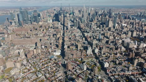 Aerial-view-of-iconic-metropolis.-Tilt-up-reveal-of-modern-tall-downtown-skyscrapers.-Manhattan,-New-York-City,-USA