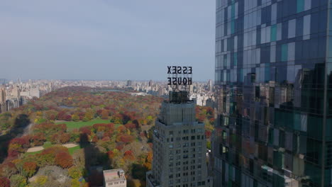 Forwards-fly-around-apartment-skyscraper-One57.-Revealing-panoramic-view-of-autumn-central-park-and-city-around.-Manhattan,-New-York-City,-USA