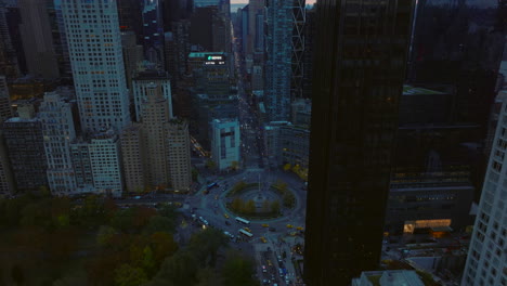 High-angle-view-of-large-multilane-roundabout-in-downtown.-Vehicles-driving-on-Columbus-Circle-at-dusk.-Manhattan,-New-York-City,-USA