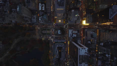 Aerial-birds-eye-overhead-top-down-view-of-evening-traffic-in-city.-Busy-roads-between-blocks-of-high-rise-buildings.-Manhattan,-New-York-City,-USA