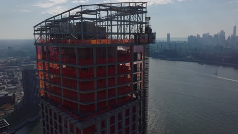 Aerial-view-of-top-of-skyscraper-under-construction.-New-high-rise-buildings-on-East-River-waterfront.-New-York-City,-USA